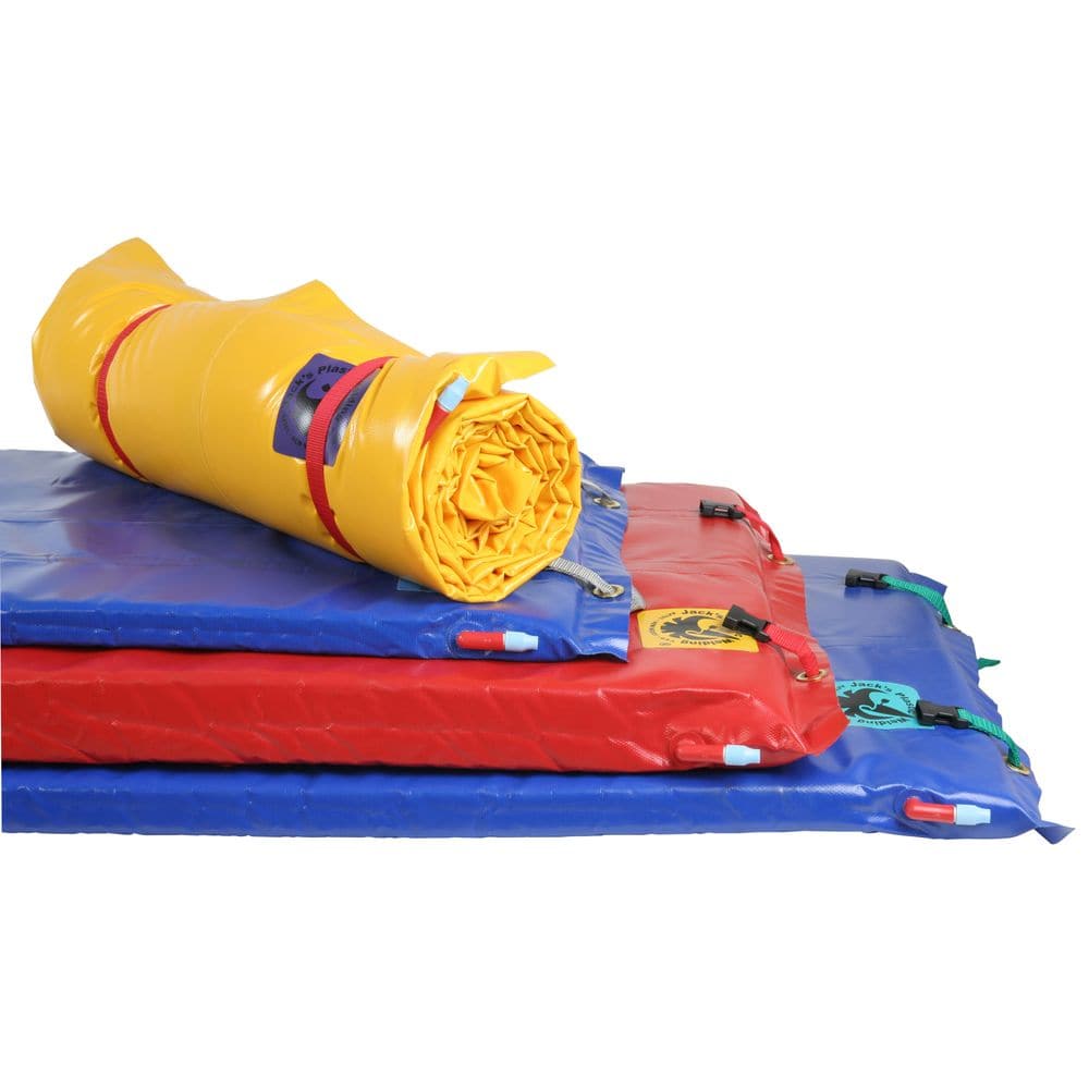 A stack of colorful crash pads includes Jacks Plastic Welding's durable Full Paco Pad with a self-inflating valve beside a bright yellow mat.