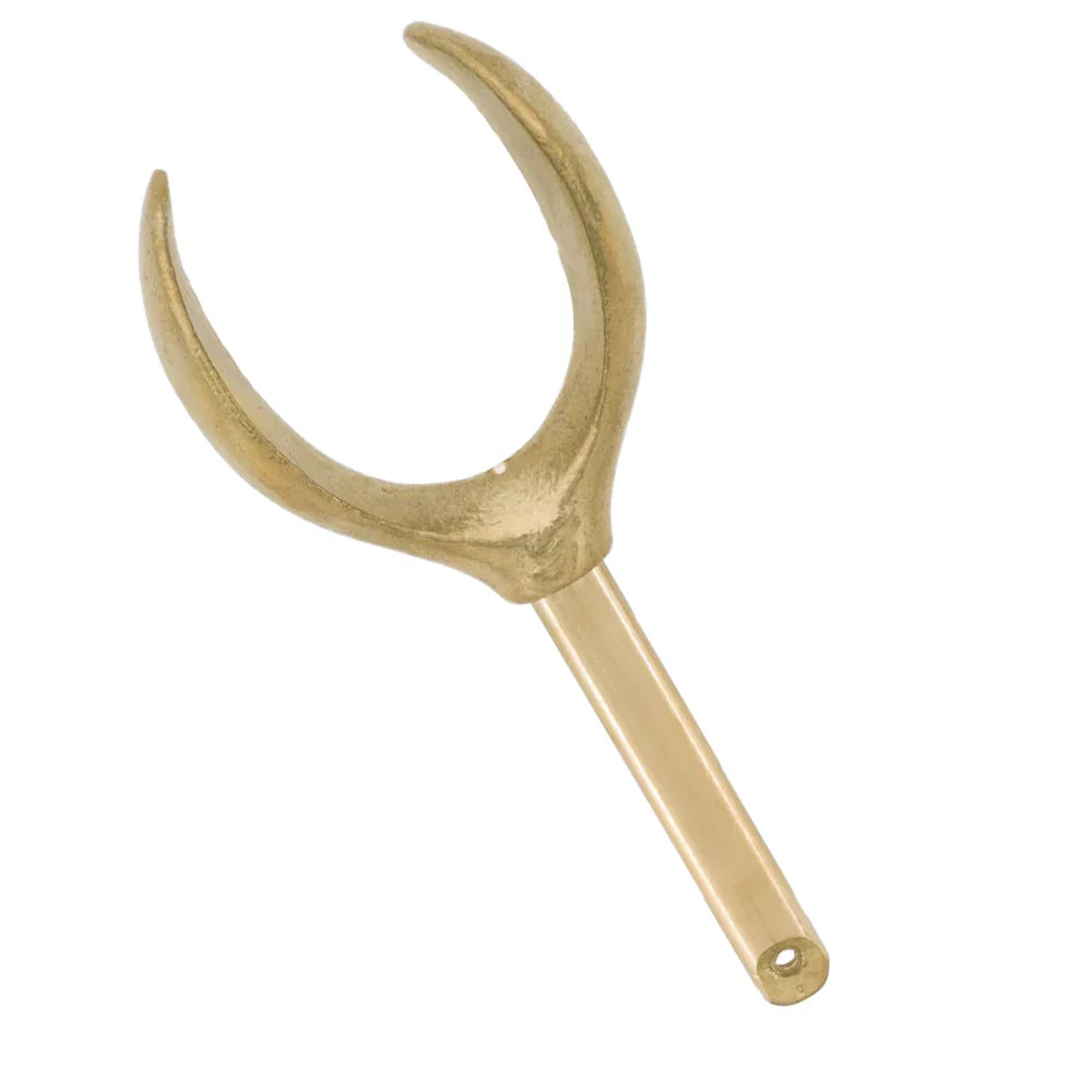 A brass tuning fork with a U-shaped design and a short handle featuring a small hole near the end.