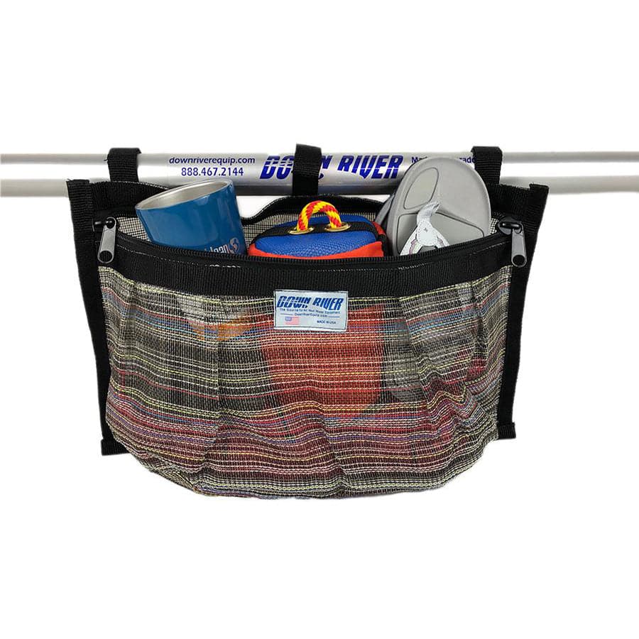 Rectangular mesh storage bag attached to a metal bar, holding a blue cup, a small case, and a pair of white sandals.