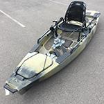 A kayak sitting in a parking lot.