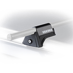 A close-up view of a Yakima rooftop mount system with a bar attached.