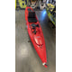 A Consignment Hobie Mirage Revolution 13 kayak by 4Corners Riversports, featuring a Vantage CT seat and two storage compartments, is displayed indoors among other kayaks.