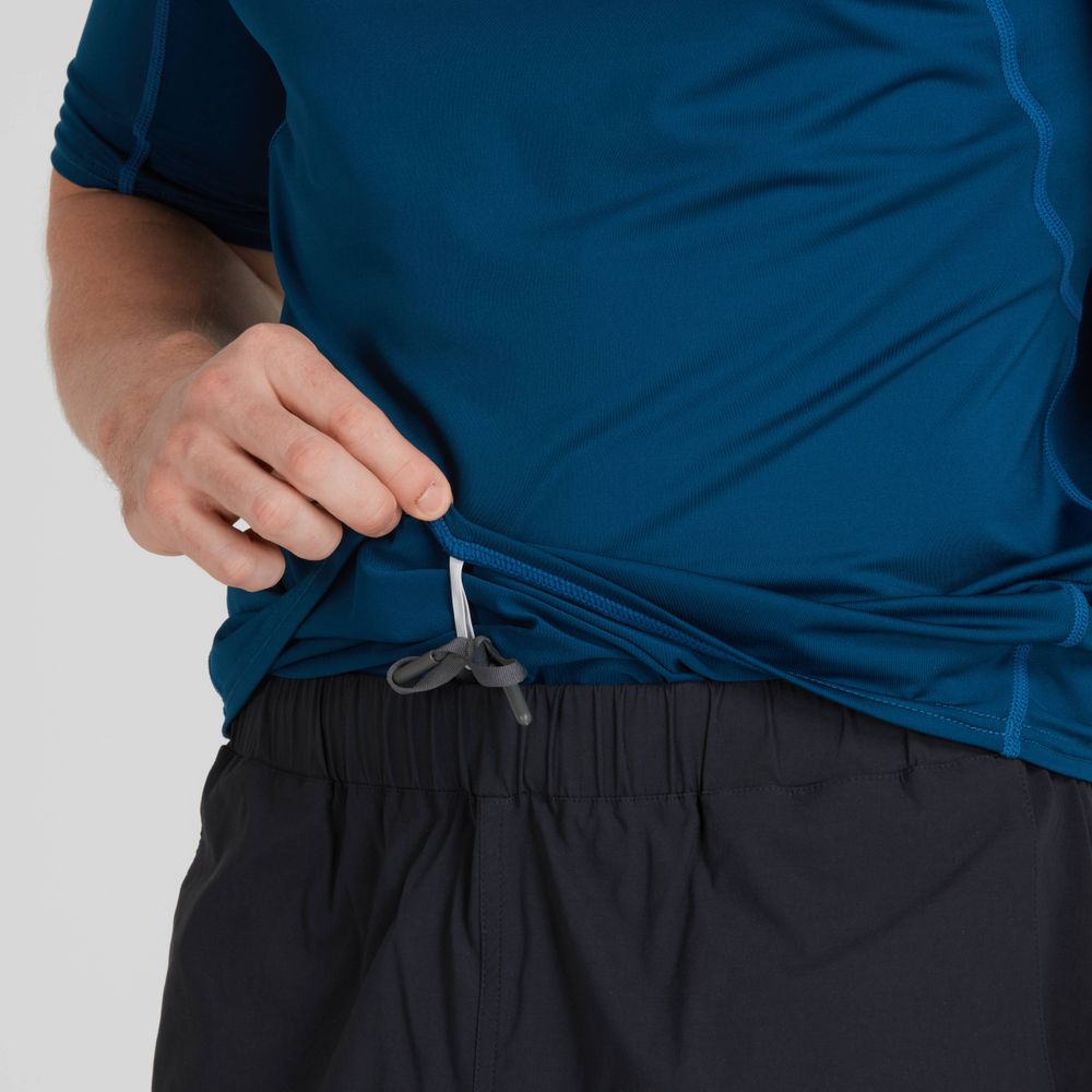A person adjusts the drawstring on a blue NRS Short-Sleeve Rashguard - Men's while wearing black shorts.