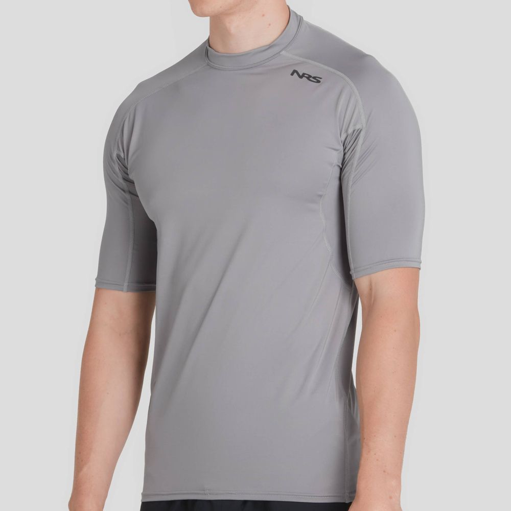 A person wearing an NRS Short-Sleeve Rashguard - Men's in gray, made with moisture-wicking fabric.