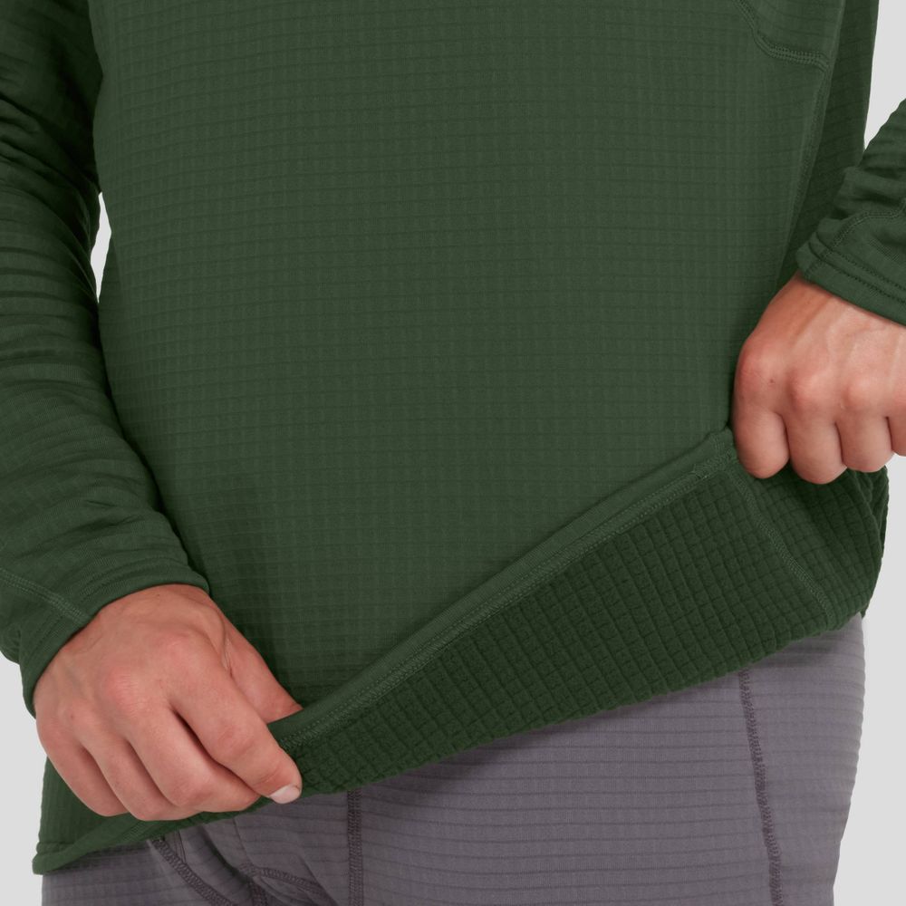 A person wearing a textured green Lightweight Hoodie for men by NRS with moisture-wicking fabric and gray pants tugs at the hoodie’s hem with both hands.