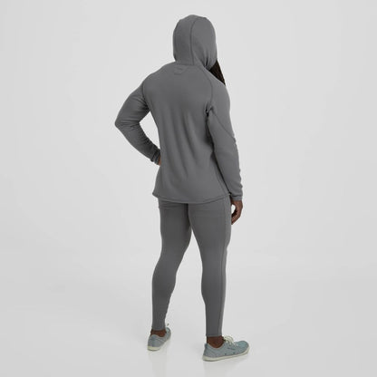 A person in an NRS men's lightweight hoodie in gray, paired with teal sneakers, stands facing away with one hand on their hip.