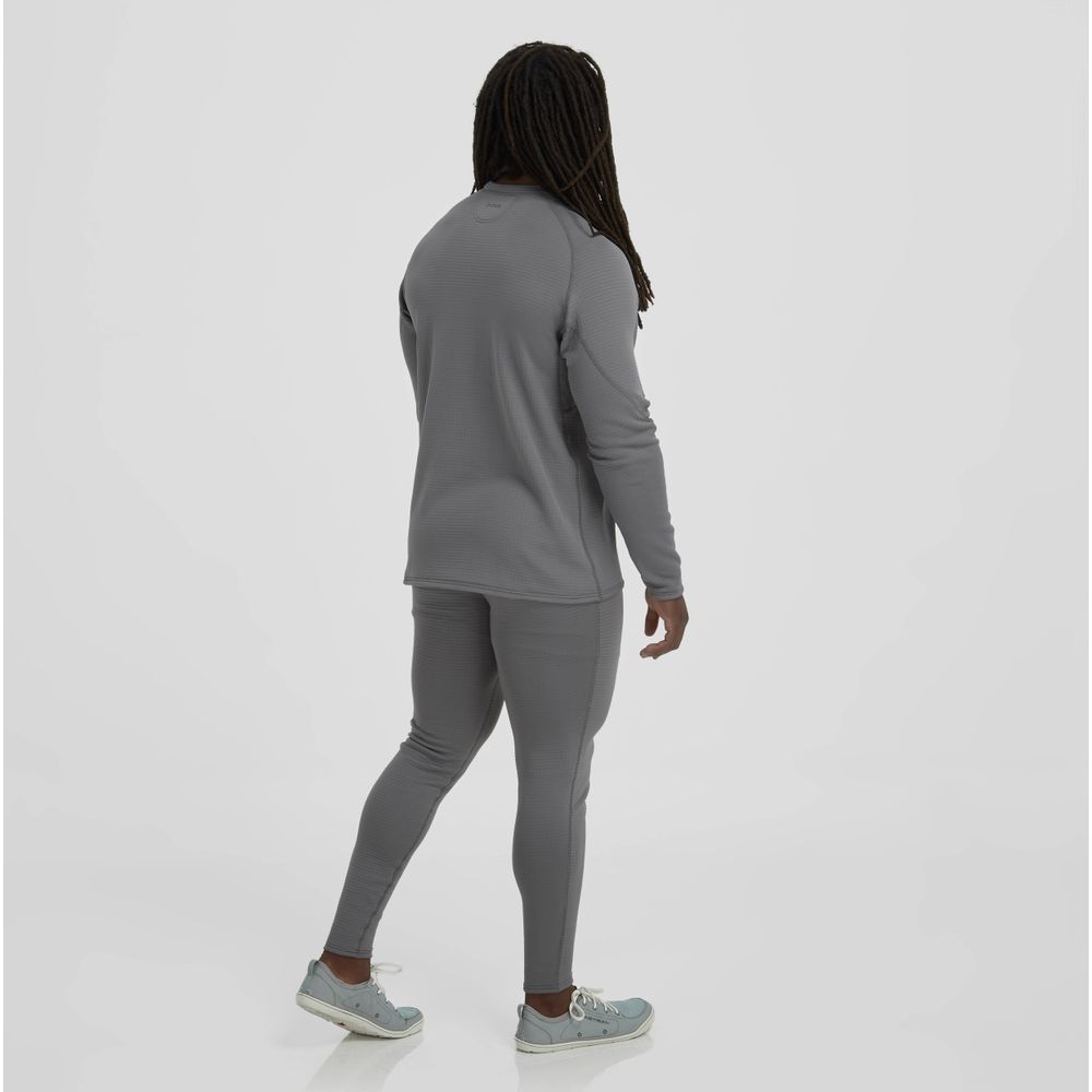 A person with long hair walks away, dressed in a gray long-sleeve top, NRS Lightweight Pants - Men's, and gray sneakers against a plain background.