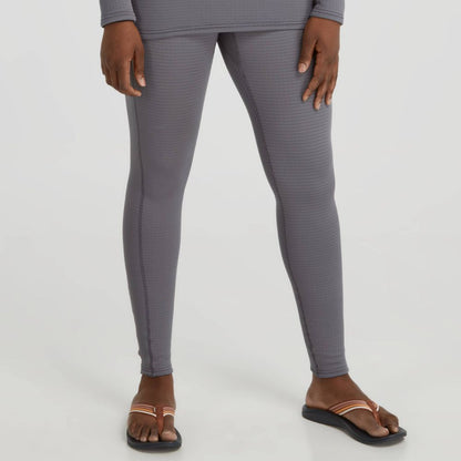 A person wearing NRS Lightweight Pants for women, featuring moisture-wicking properties, and black sandals stands against a plain background.