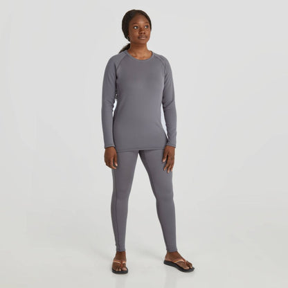 A person, wearing a gray long-sleeved top and dark sandals, stands against a plain background in Lightweight Pants - Women's from NRS featuring UPF 50+ sun protection.
