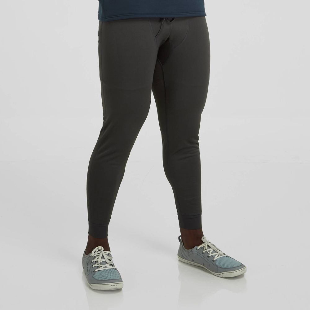 A person wearing NRS Expedition Weight Pants - Men's stands on a plain white background, paired with gray-blue sneakers.