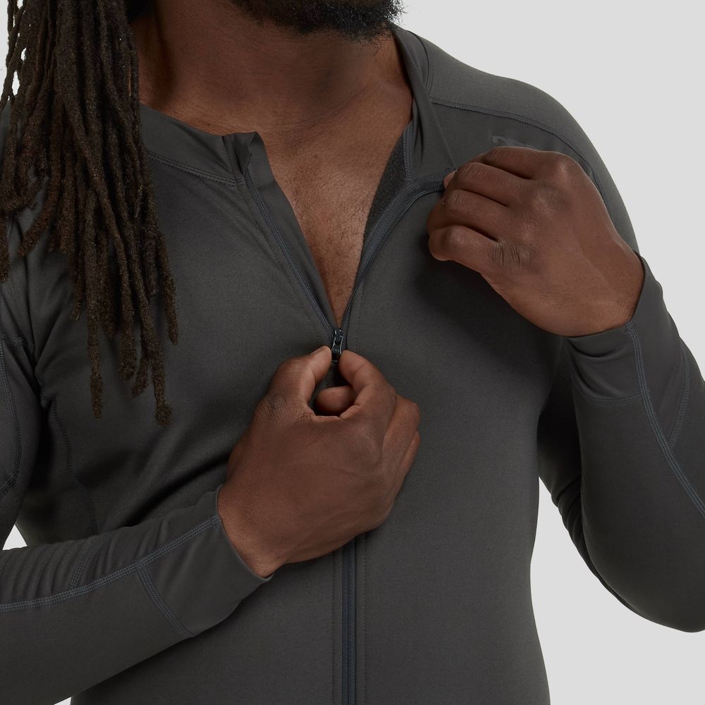 A long-haired person zips up the NRS Expedition Weight Union Suit - Men's, a dark, recycled-material long-sleeve athletic jacket designed for paddlers' mobility and enhanced expedition insulation.