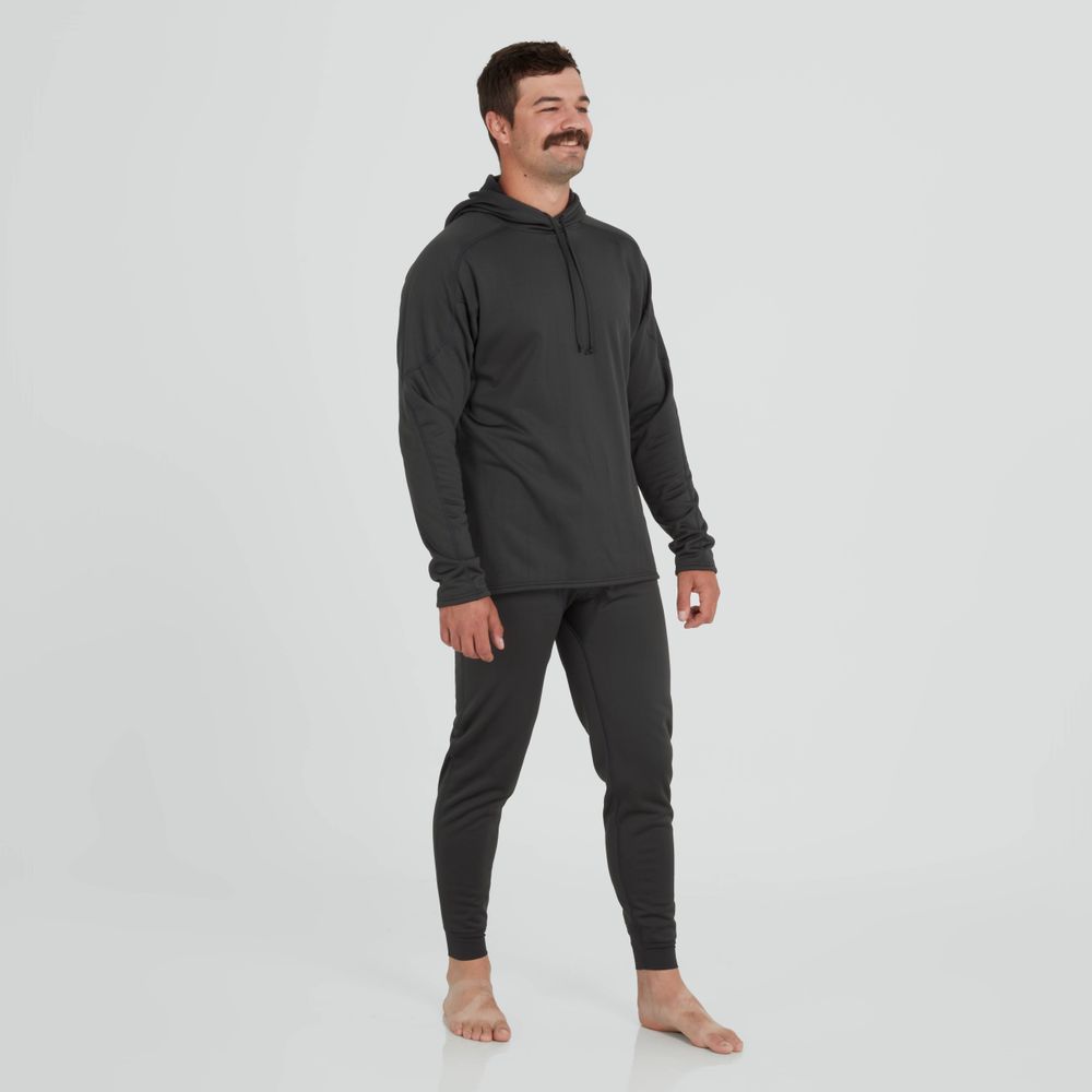 A person in an NRS Expedition Hoodie - Men's, stands barefoot on a plain background, smiling with ease. The high-stretch fabric enhances comfort while the breathable fleece keeps them cozy.