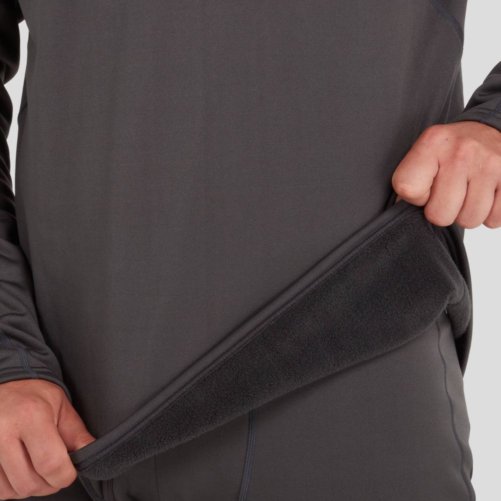 A person wearing the NRS Expedition Hoodie - Men's is lifting the hem to showcase its intricate, high-stretch fabric texture.