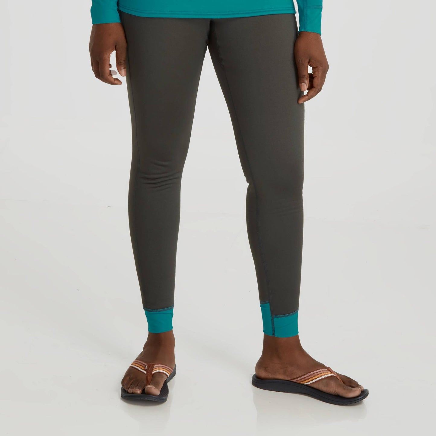 A woman wearing NRS Expedition Weight Pants - Women's and a green top.