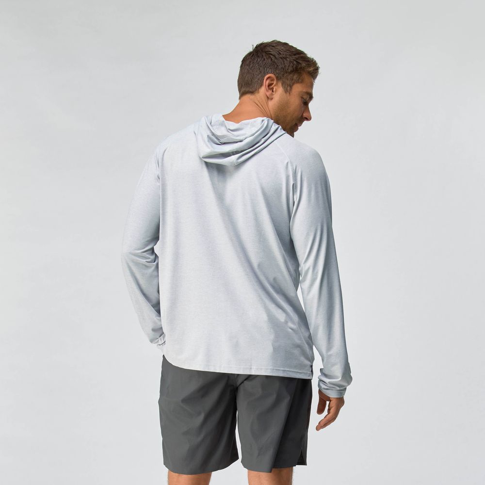 A man faces away from the camera, wearing the NRS Silkweight Hoodie - Men's in light gray with moisture-wicking fabric and dark gray shorts, set against a plain light background.