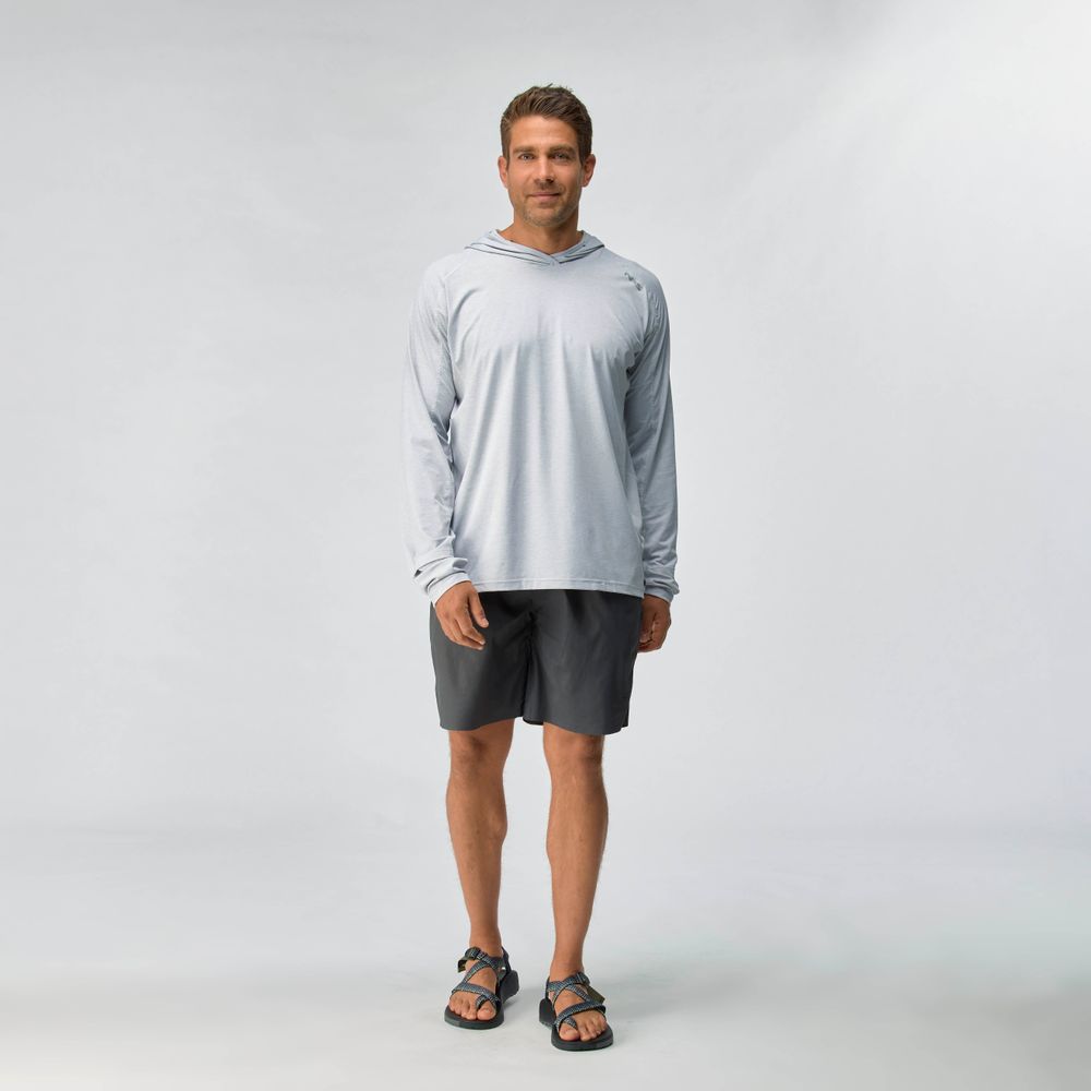 A man faces forward wearing the NRS Silkweight Hoodie - Men's in light gray, paired with dark gray shorts and black sandals, standing against a plain light background.