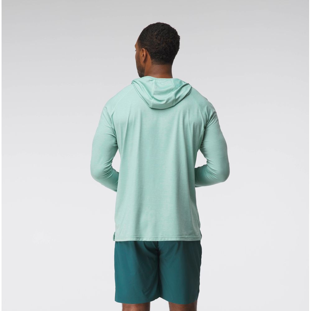 A man faces away from the camera wearing the NRS Silkweight Hoodie - Men's in light green and dark green shorts, set against a plain background—ideal for sun protection and moisture wicking.