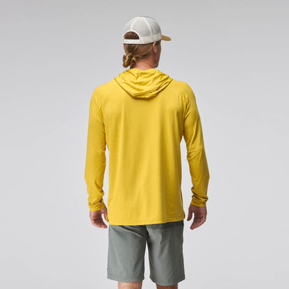 A man faces away, wearing the NRS Silkweight Hoodie - Men's in yellow for sun protection, paired with gray shorts and a white trucker hat, set against a plain light background.