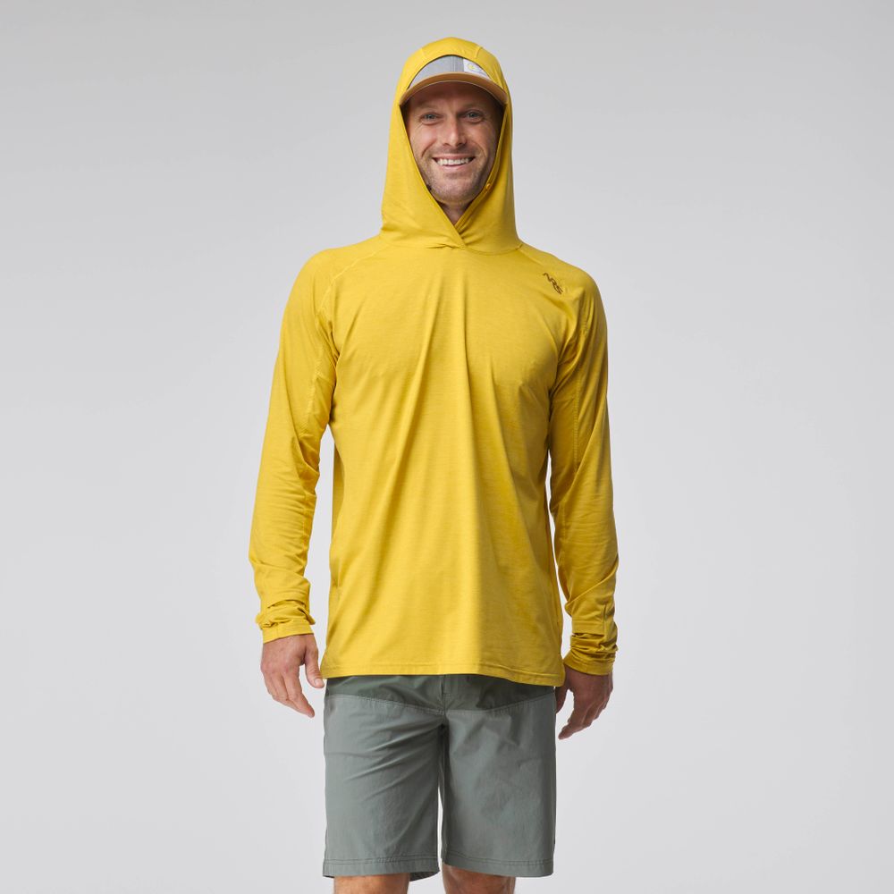 A person wears an NRS Silkweight Hoodie - Men's in yellow, a matching cap, and gray shorts, standing forward and smiling against a plain light background.