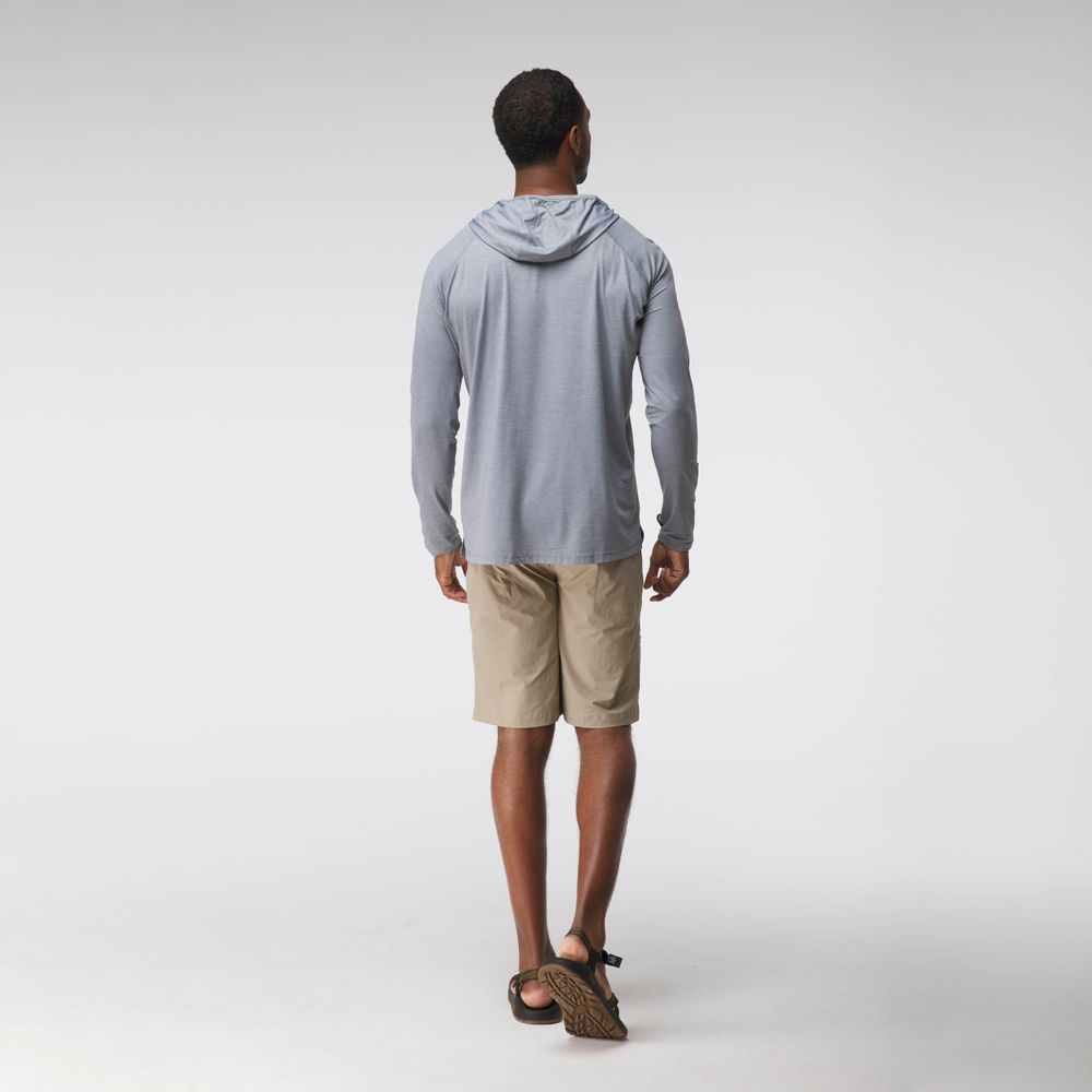 A man faces away from the camera wearing the NRS Silkweight Hoodie - Men's in light gray, paired with tan shorts and sandals, against a plain white backdrop.