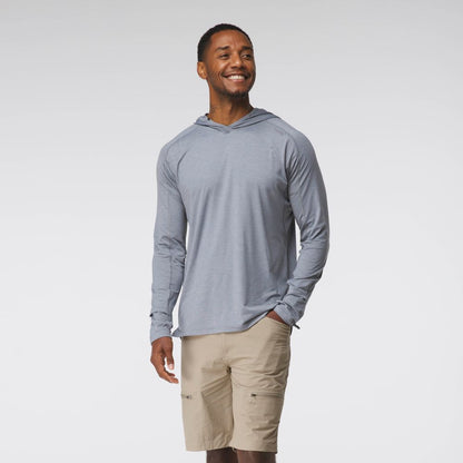 A man wearing the NRS Silkweight Hoodie for men and beige shorts smiles against a plain white background, highlighting comfort and sun protection.
