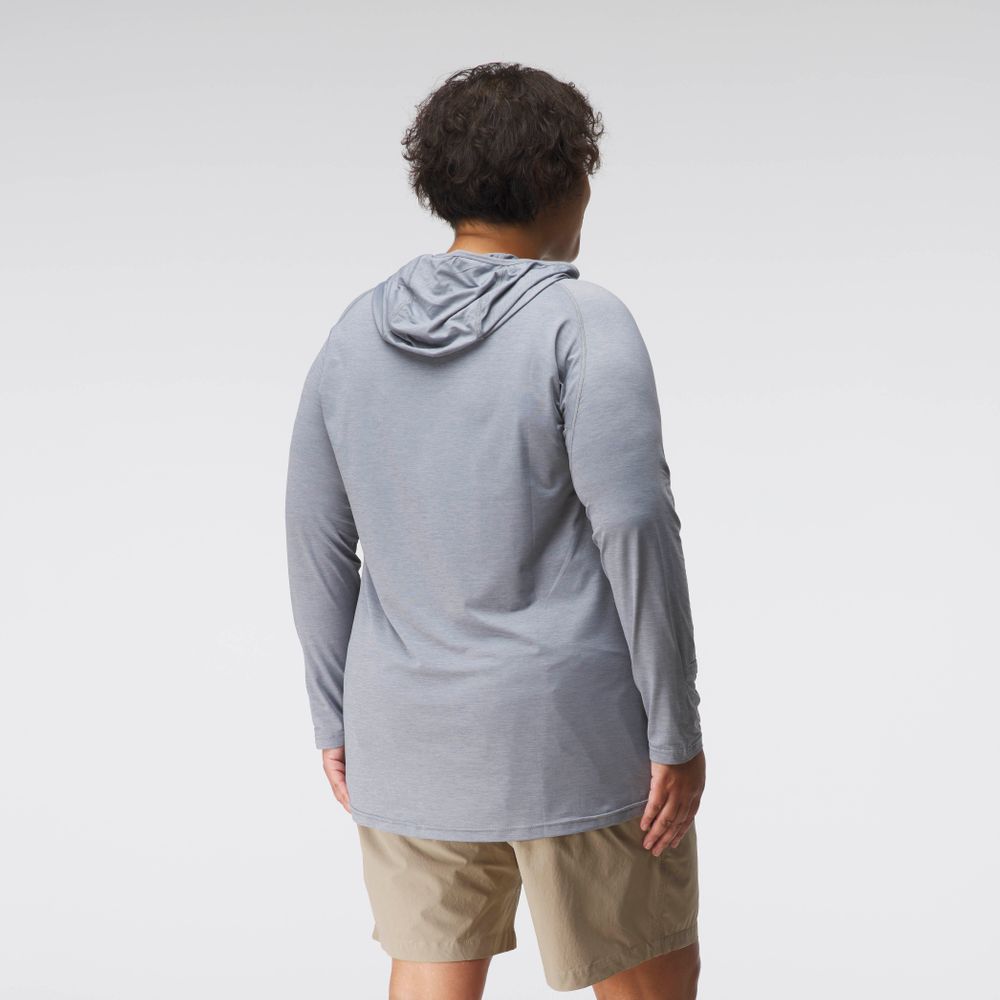 A woman faces away from the camera, wearing the NRS Silkweight Hoodie - Women's in light gray with khaki shorts, set against a plain white background.