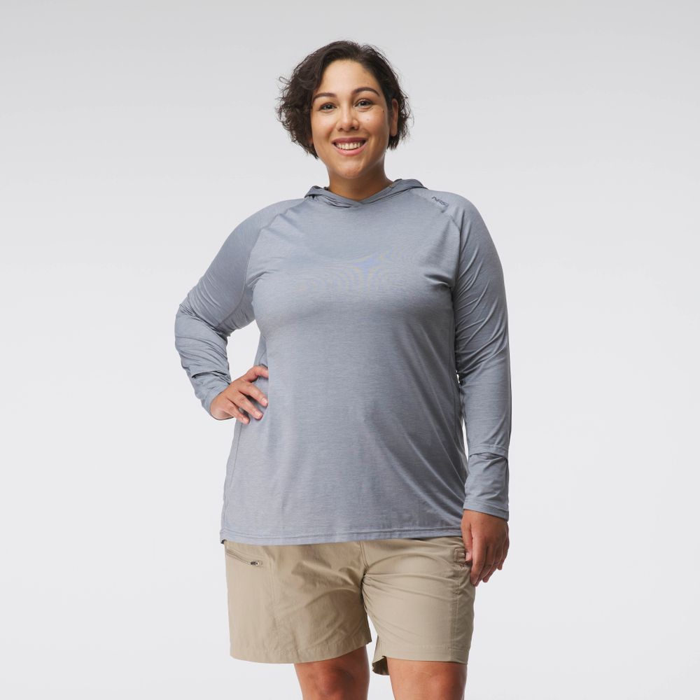 A woman models the NRS Silkweight Hoodie in light gray with tan shorts, facing the camera against a plain white background, showcasing stylish sun protection.