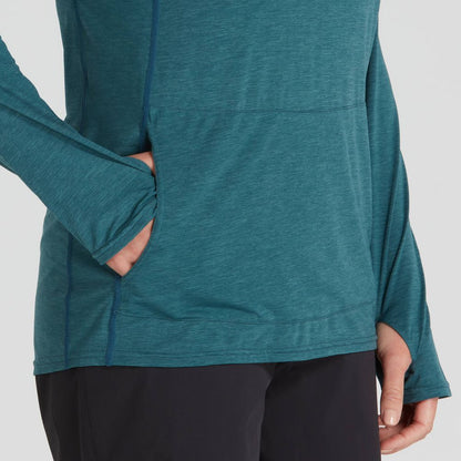 A person wearing the NRS Silkweight Vesi Hoodie for women in teal, featuring UPF 50+ sun protection, with their left hand in the front pocket, paired with black pants.