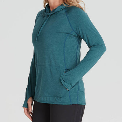 A person is wearing the NRS Silkweight Vesi Hoodie - Women's in teal, featuring a hood and thumbholes for UPF 50+ sun protection, paired with black pants, facing right.