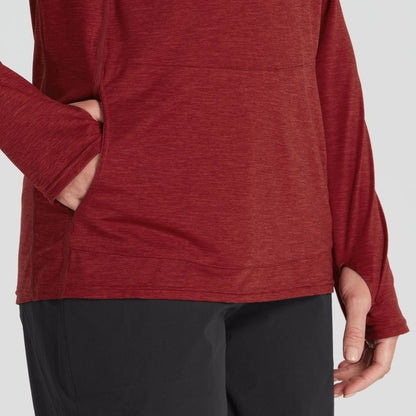 A person wears a women's NRS Silkweight Vesi Hoodie in red, featuring long sleeves and a convenient shirt pocket, paired with black pants. The stylish outfit offers comfort and UPF 50+ sun protection.