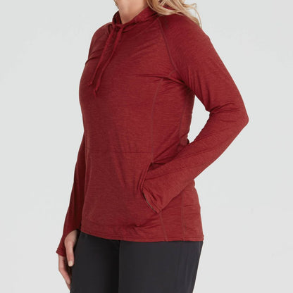 A person in a red NRS Silkweight Vesi Hoodie - Women's, with black pants and one hand in their pocket, stands against a plain background. The hoodie provides UPF 50+ sun protection while remaining breathable.