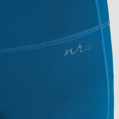 Close-up of a person wearing blue NRS Ava Rashguard Pants - Women's, showcasing side stitching and logo near the hip. These eco-friendly swim tights offer UPF 50 sun protection and are made from recycled fabric.