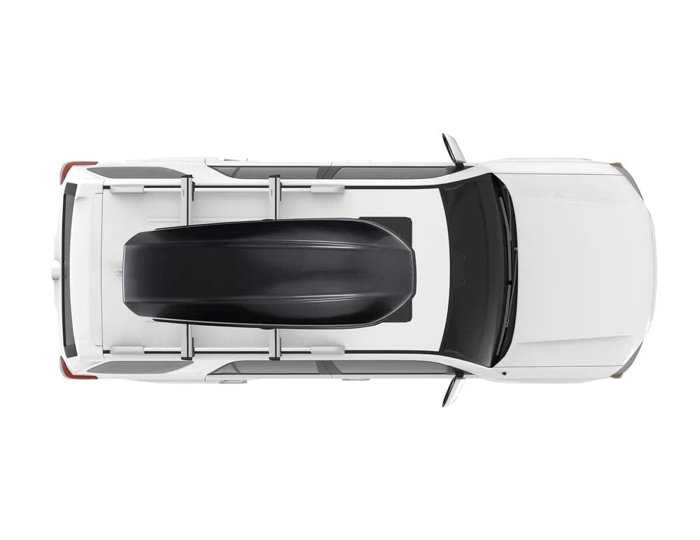 An aerial view of a white car with a Yakima Skybox 21 Carbonite roof rack.