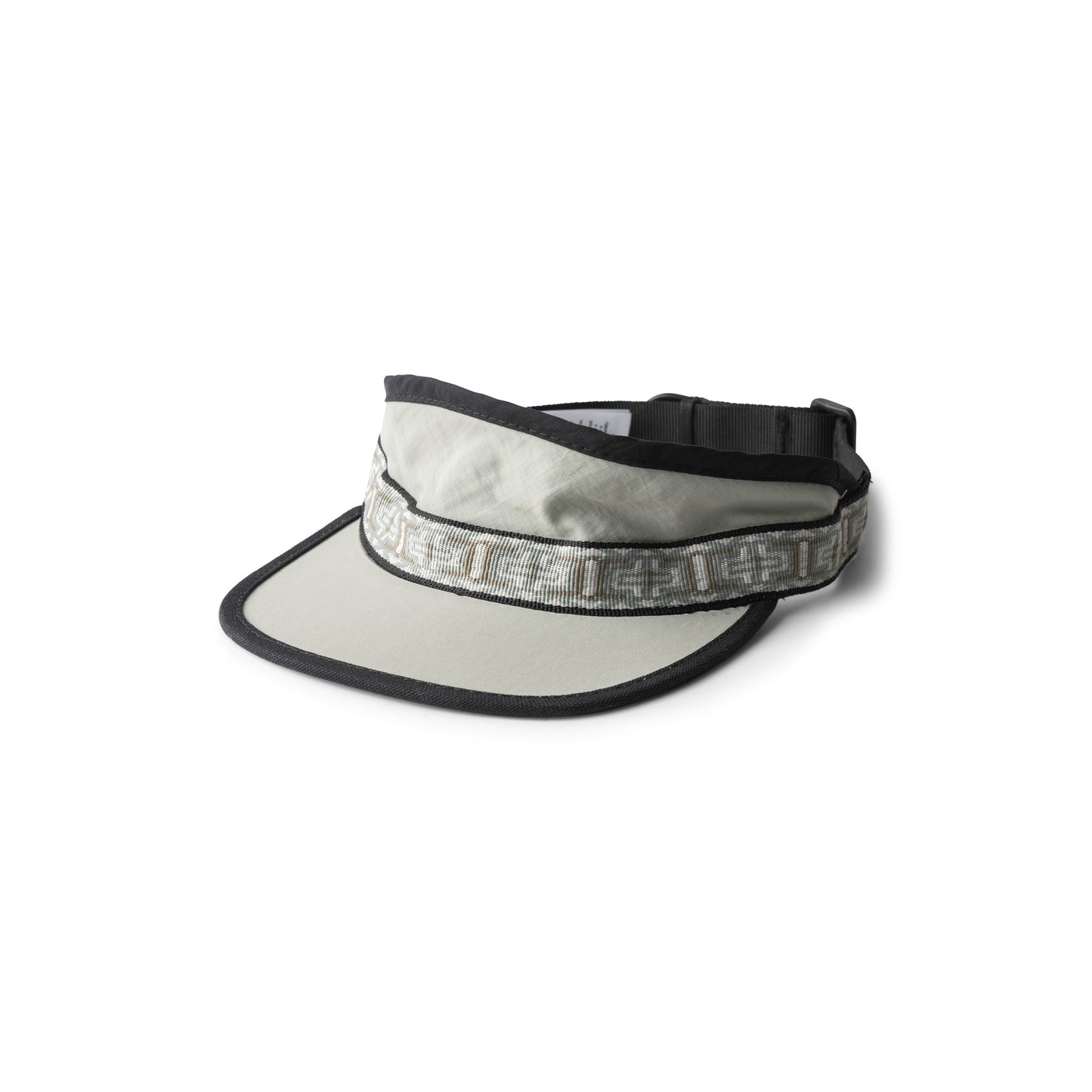 The Kavu Synthetic Strapvisor is a light gray visor with black trim, an adjustable strap, and a patterned band around the crown.