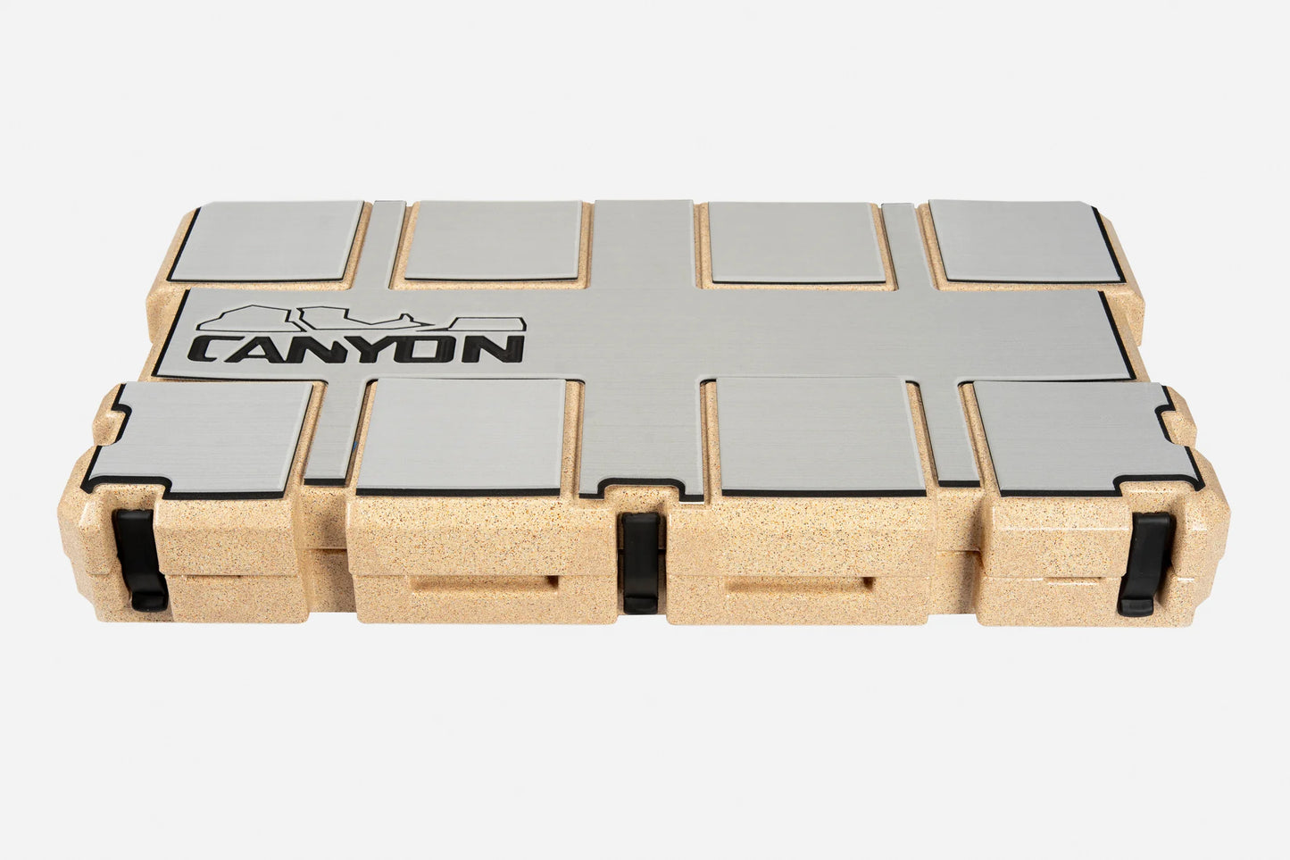 Rectangular cork and metal case with black latches and "Canyon Coolers" logo on the lid, featuring an EVA foam liner, contains Cooler Traction Pads; shown closed against a white background.