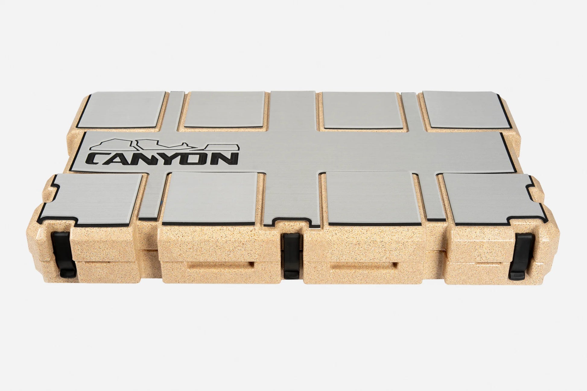 Rectangular cork and metal case with black latches and "Canyon Coolers" logo on the lid, featuring an EVA foam liner, contains Cooler Traction Pads; shown closed against a white background.