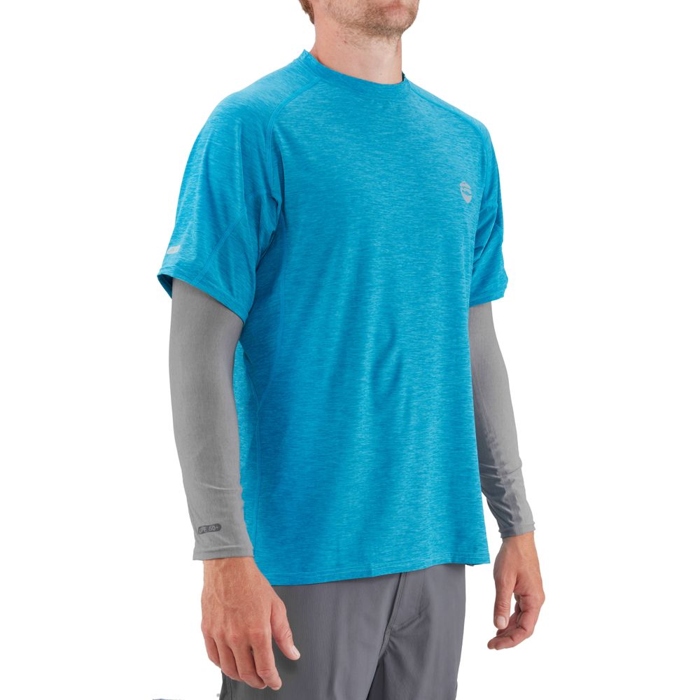 A man stands against a white background wearing gray NRS H2Ozone Sun Sleeves paired with a blue short-sleeve shirt and gray pants, highlighting sun protection through lightweight fabric.