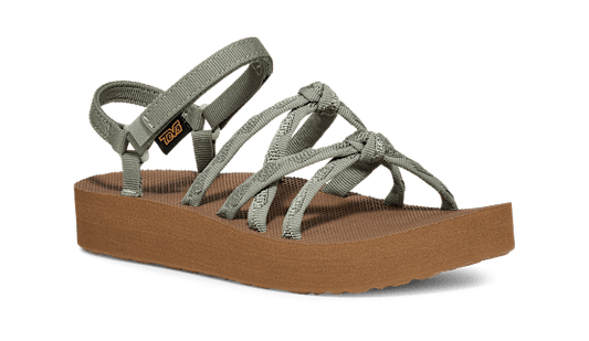 The DECKERS Women's Midform Kena Slim Sandal features a light green strappy upper, thick brown cushy EVA sole, adjustable ankle strap, recycled materials, and the Teva logo on the side for all-day comfort.
