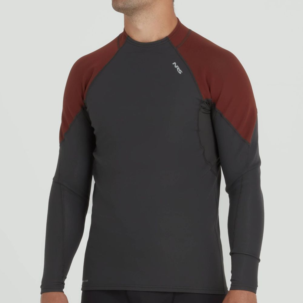 A person wearing an NRS Hydroskin 0.5mm Long Sleeve Shirt - Men's in dark gray and maroon stands against a light background, showcasing their paddling prowess.