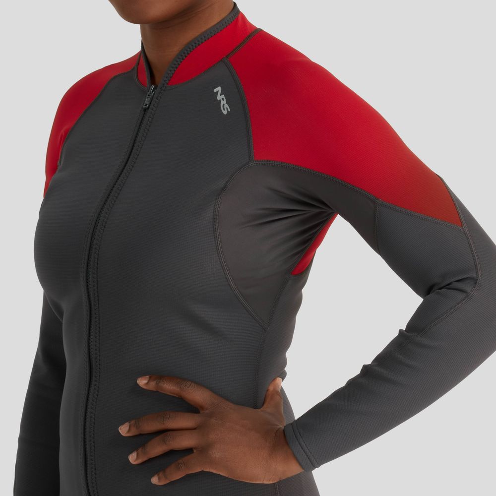 A person confidently poses in the NRS Hydroskin 0.5mm Jacket - Women's, hand on hip, embodying seamless paddling performance. The sleek gray and red wetsuit design is ideal for aquatic adventures against a plain backdrop.