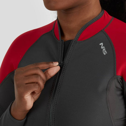 A person in the NRS Hydroskin 0.5mm Jacket for women, which is grey and red neoprene, partially unzips the front to enhance paddling performance.