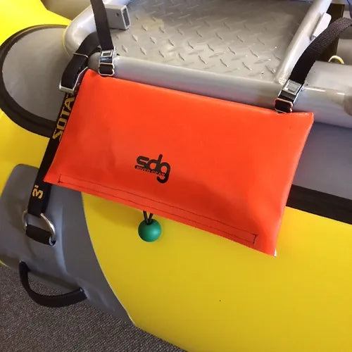 A yellow SDG Raft Ladder with an orange SDG River Gear bag attached to it.