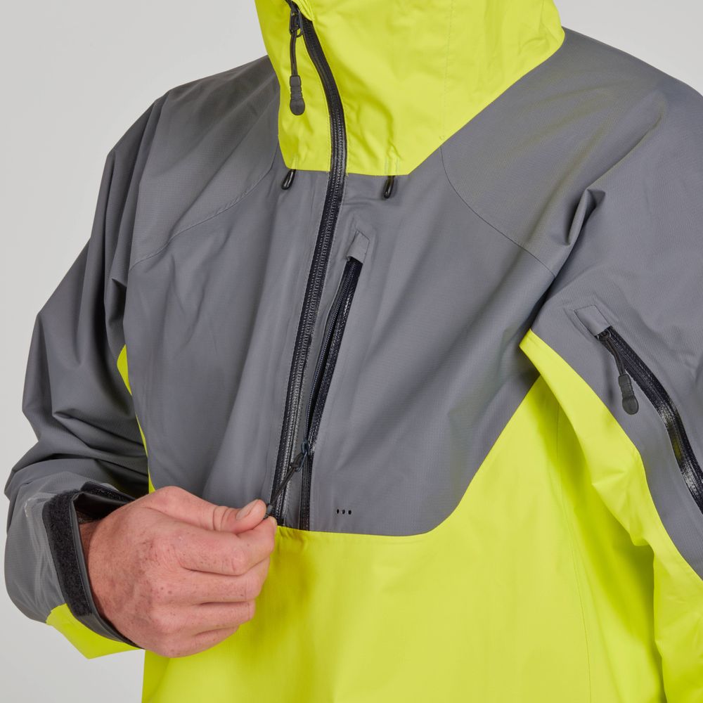 Someone adjusts the zipper on the NRS High Tide Men's Jacket, a breathable neon yellow and gray two-toned paddling jacket with a high collar.