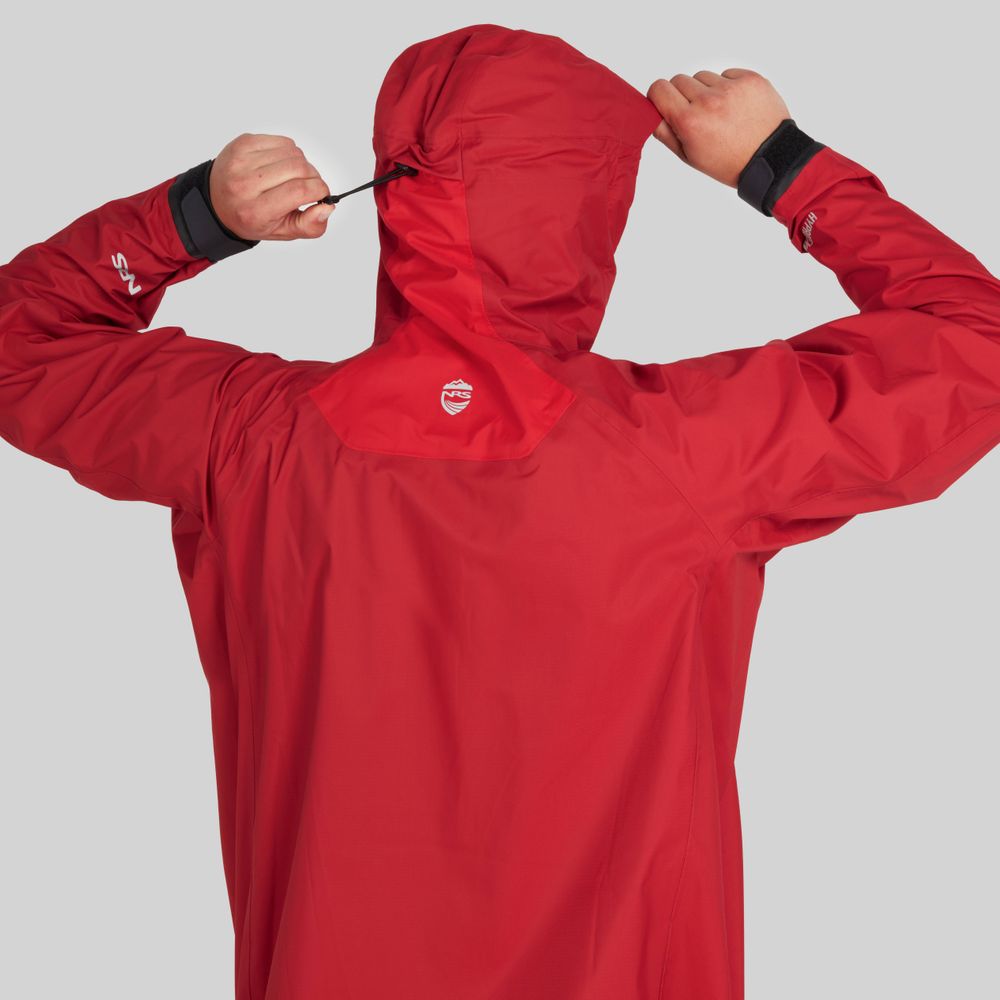 The individual tightens the drawstring on the hood of their NRS High Tide Jacket - Men's in red, seen from behind against a gray backdrop.