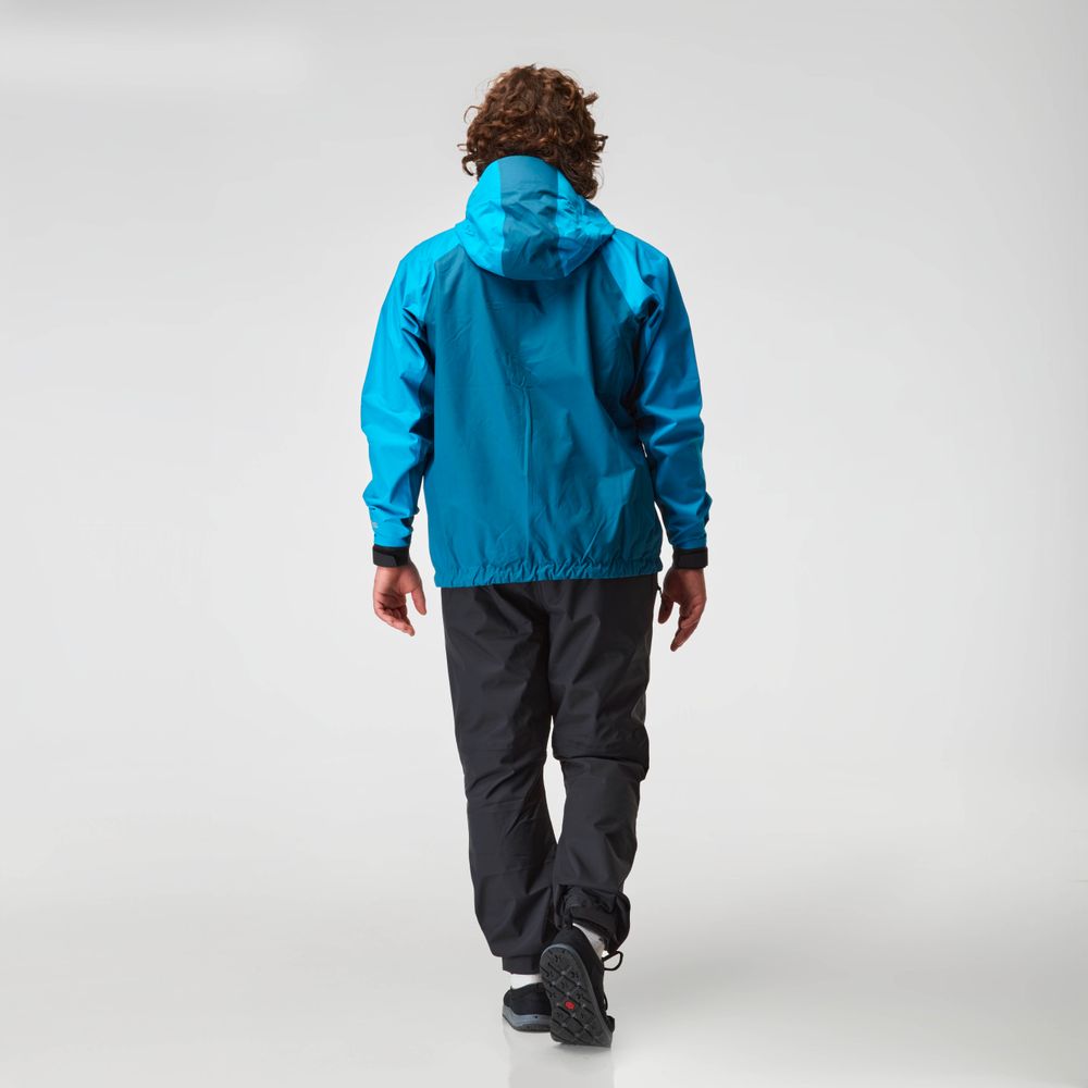 A person in an NRS High Tide Jacket and black pants walks away on a light background.