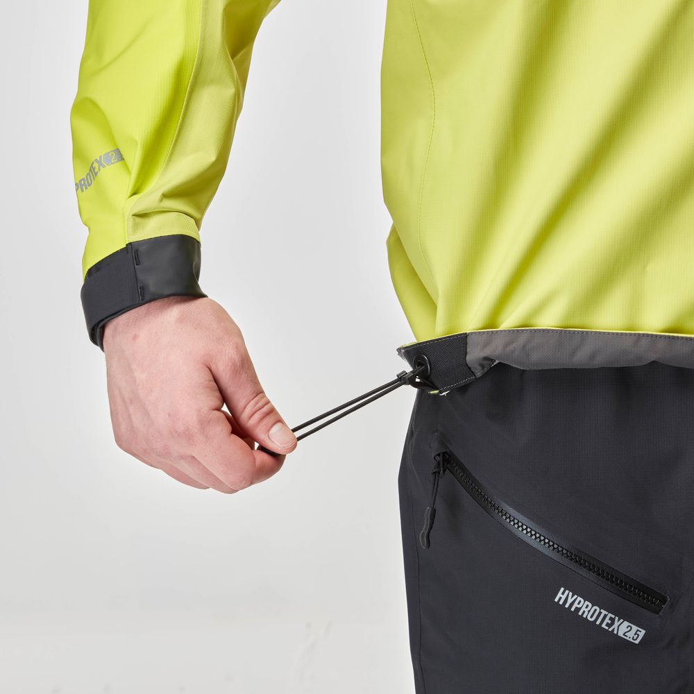 A person tightens the black drawstring on a yellow NRS High Tide Jacket for men with gray cuffs, branded "HYDROTEX 2.5", ideal for paddling.