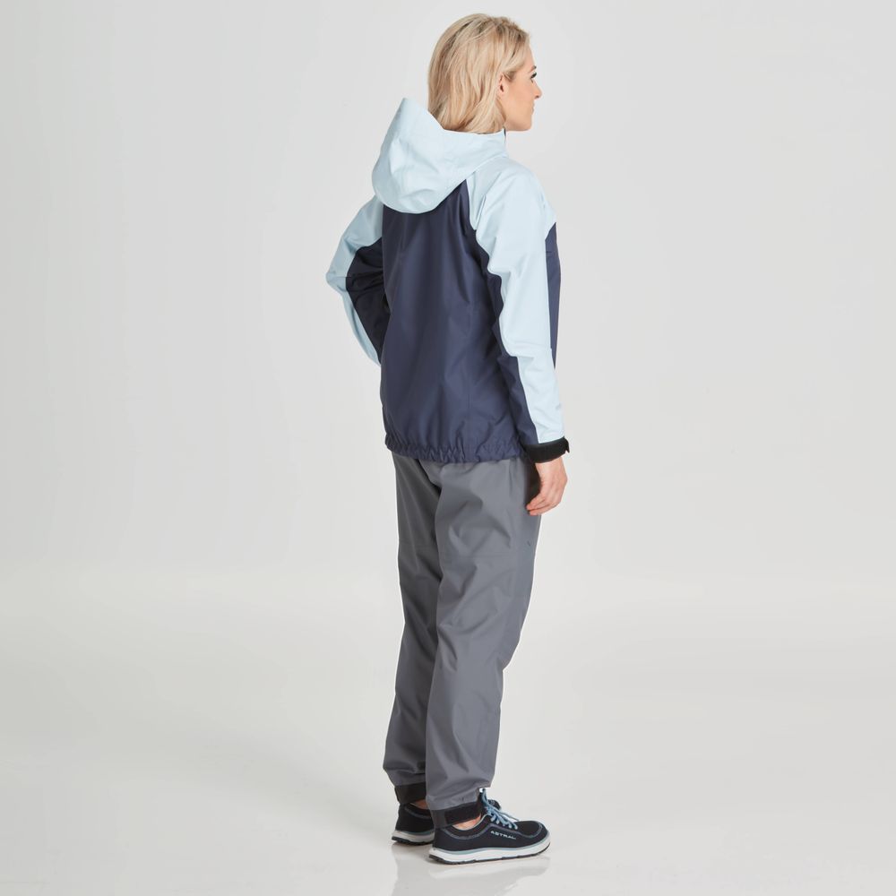 A person wearing the NRS High Tide Jacket - Women's in two-tone, paired with gray pants, stands sideways on a plain background.