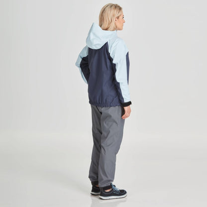 A person wearing the NRS High Tide Jacket - Women's in two-tone, paired with gray pants, stands sideways on a plain background.