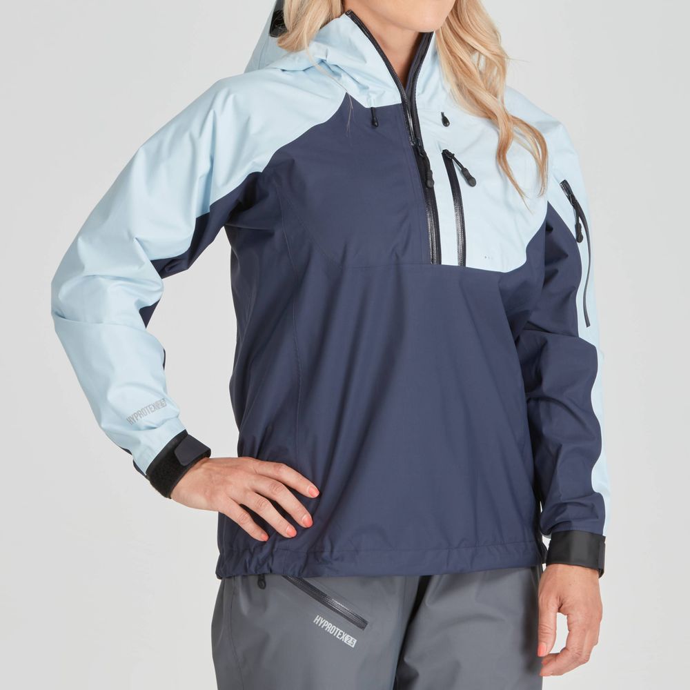 A person is wearing the NRS High Tide Jacket - Women's, featuring a two-toned design with light blue arms and a dark blue torso. This breathable splash jacket offers the perfect paddler's cut when paired with matching pants.