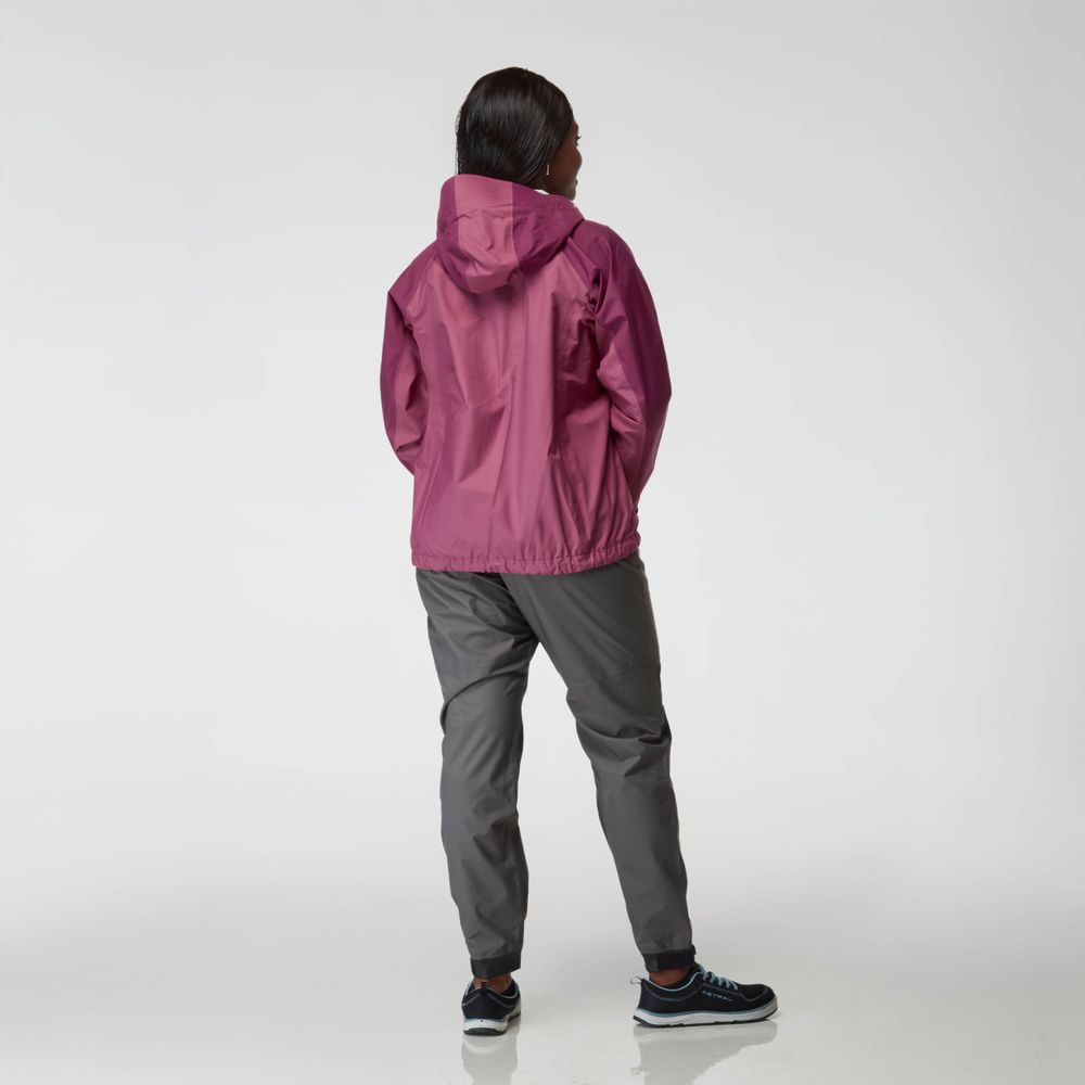 A woman in a maroon NRS High Tide Jacket with an adjustable hood and gray pants stands facing away against a plain background.